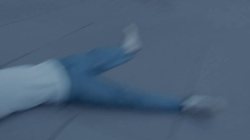 Man lying on the ground laughs as another person approaches him