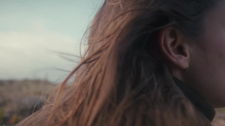 Wind blows through her hair as she keeps her gaze fixed ahead