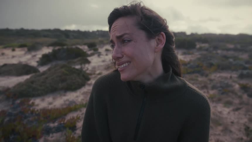The woman is crying on a windy day