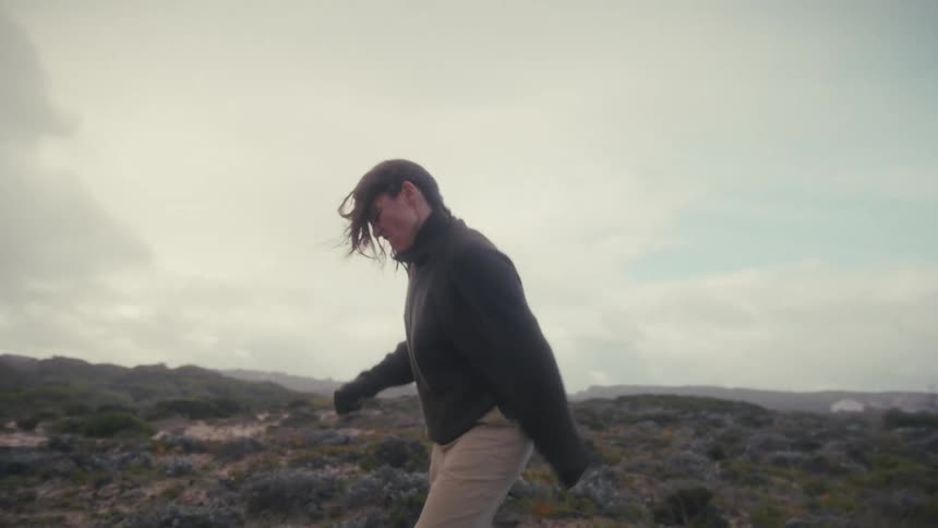 An upset woman screams as she paces in a circle