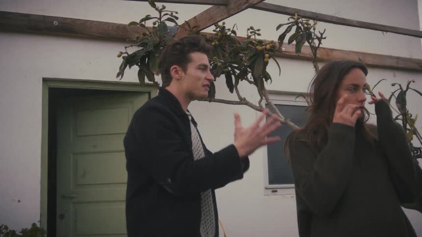 Man gestures while the woman covers her face amid an argument