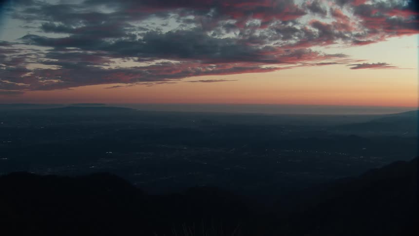 Clouds over buildings in the valley at dusk