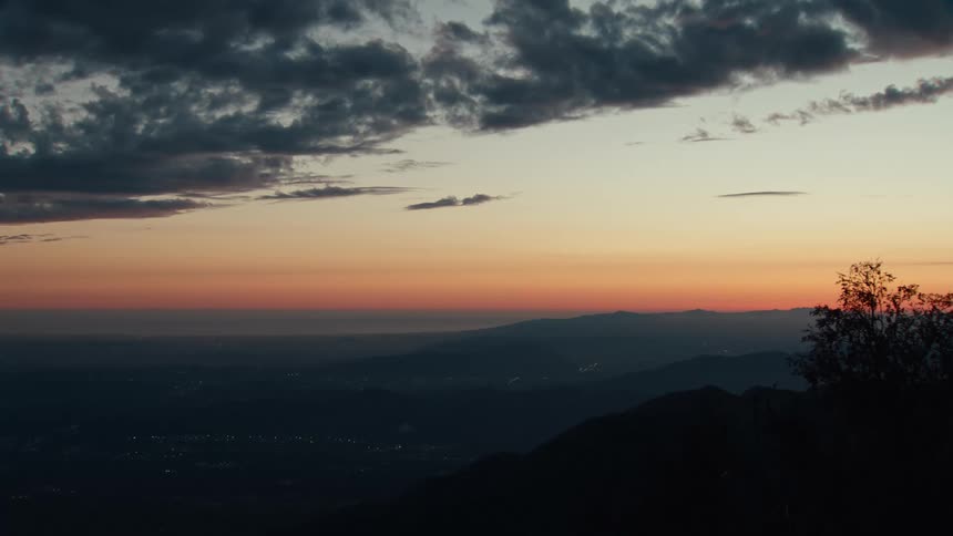 The sunset in the distance over some mountains