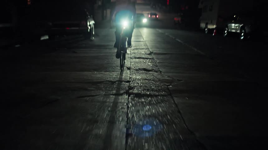 A man riding a bike up a hill