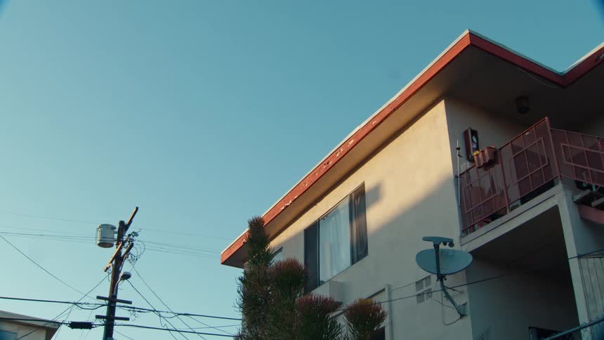 A satellite dish is on the side of the home