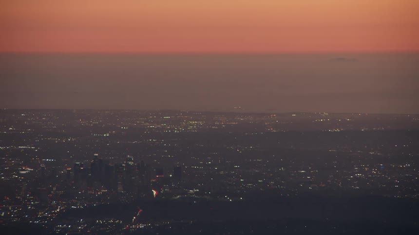 The city is lit up as the sun sets