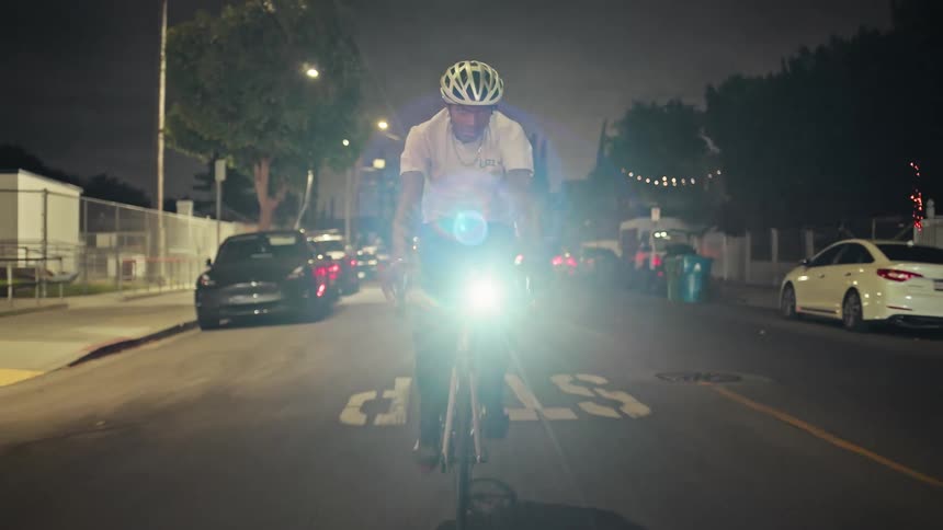 The man pedals his bike down the road