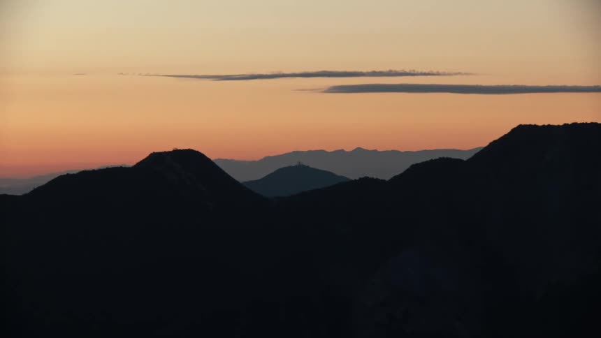 A view of the sun setting over mountains