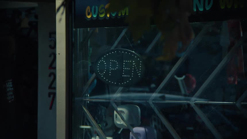 Man turns off the illuminated open sign