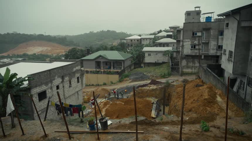 Construction workers are working on the foundation of a building in a rural town