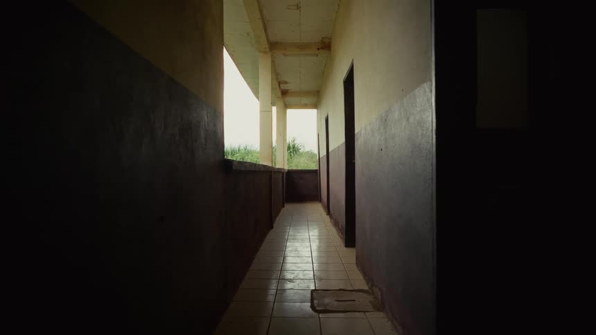 An empty corridor indoors in a rural building during daytime