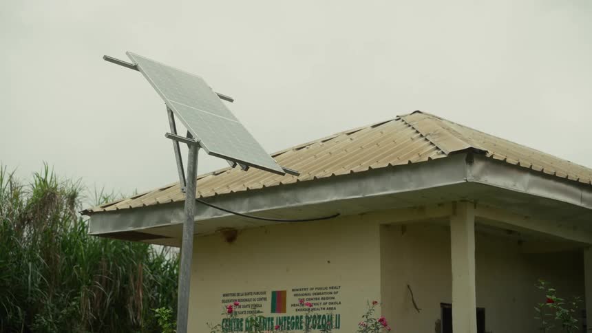 Solar panel installed beside the roof of a small rural building