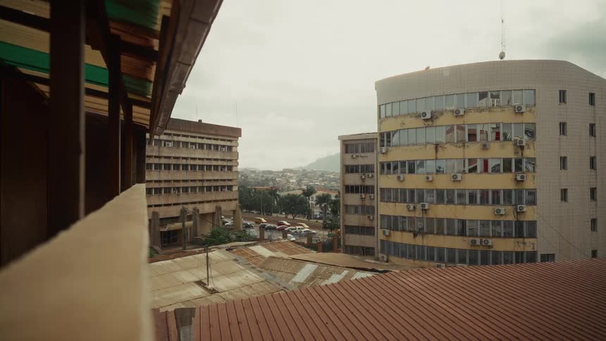 Commercial buildings with aged facades and air conditioners facing the street