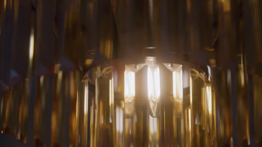 Golden lights reflect on the crystals of an elegant chandelier