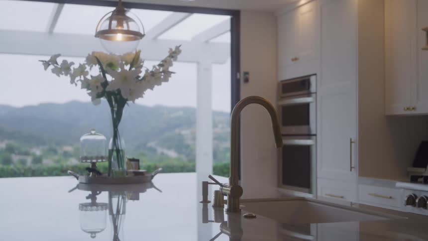 Bright kitchen reveals a mountain view through glass doors