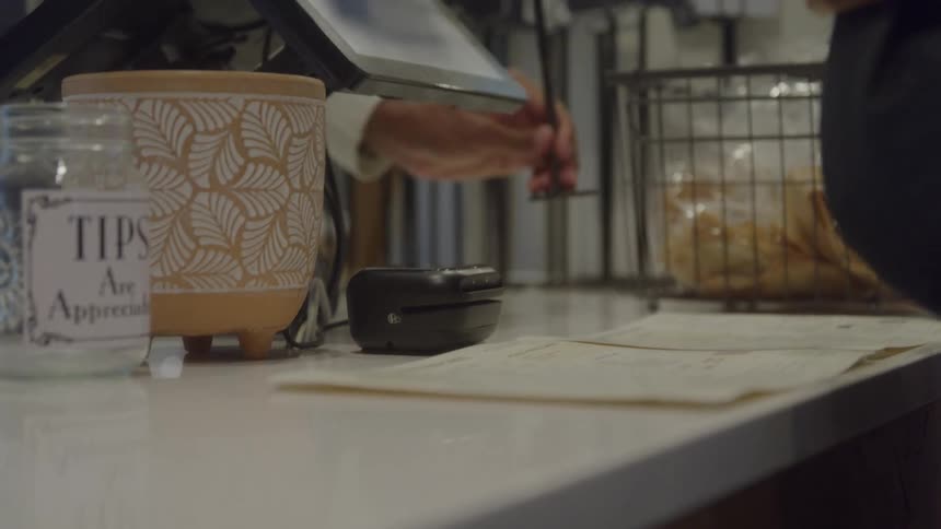 Customer makes a contactless payment at a caf counter