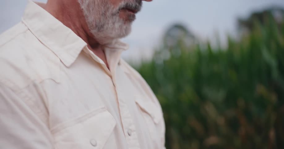 Man holds a walkietalkie while working in the field