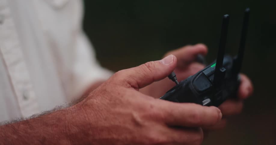 The man is using a controller outside