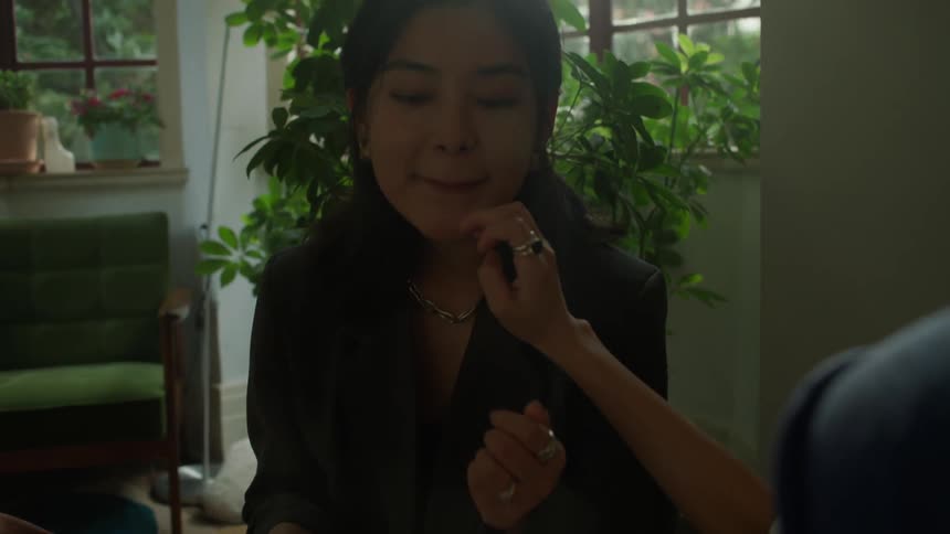 Woman receiving a gentle touch on her face while making a playful expression