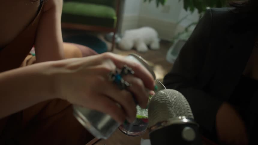 A woman mixing a cocktail likely a refreshing fruit based drink with a stylish flair