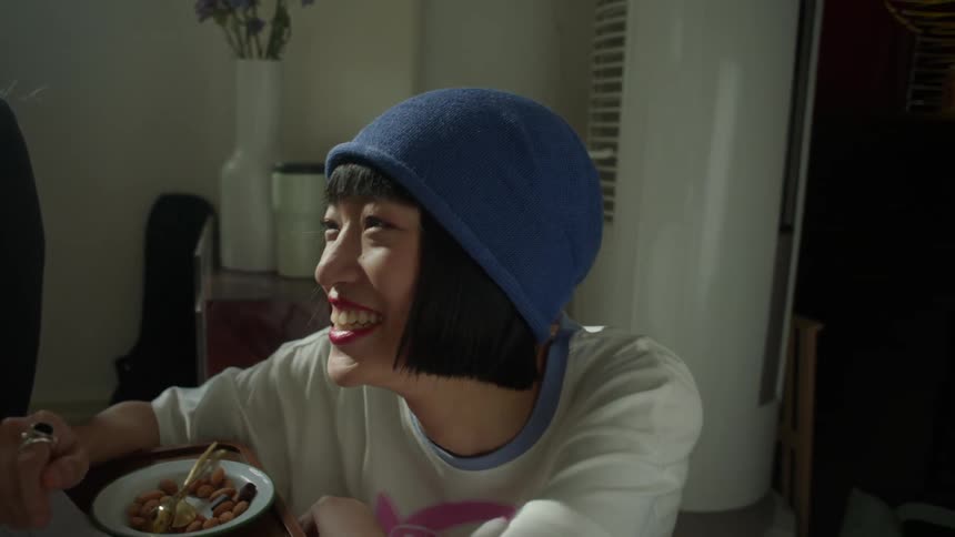 Women chatting and smiling while sharing a moment at the table