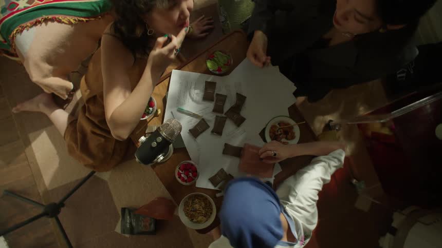 The women laugh and talk as they eat snacks