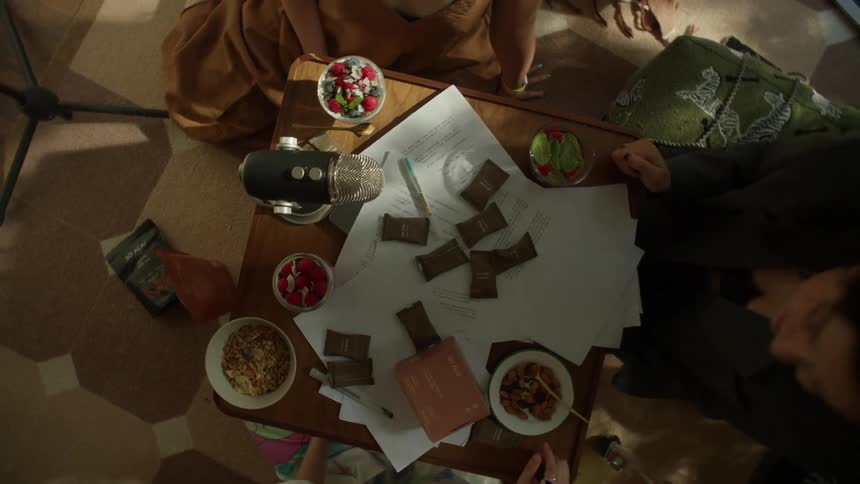 Friends sitting around a table talk during a meal
