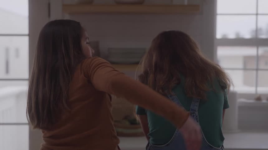 The girl hugs her friend at home
