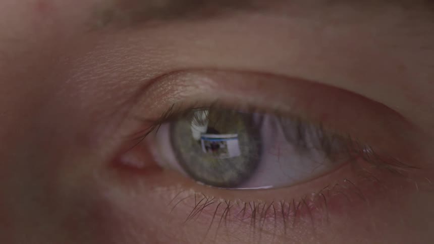 A close up of a persons eye that is moving and blinking