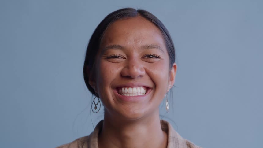 Woman standing smiling and showing her teeth