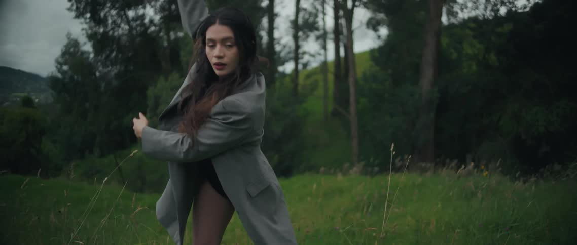 The woman dances in the tall grass