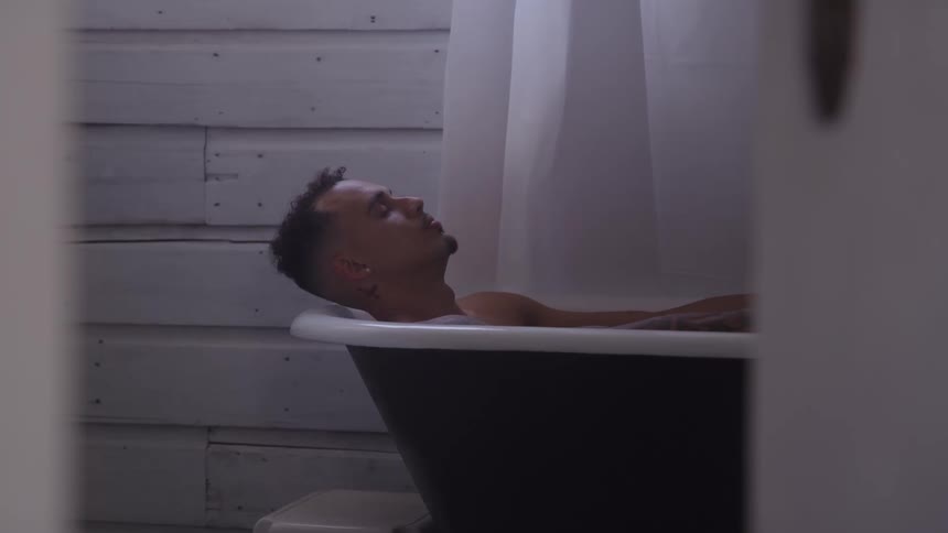 Man relaxing in a bathtub in a quiet setting