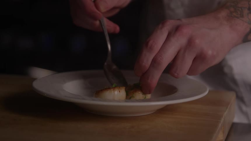 The chef carefully plates the dish
