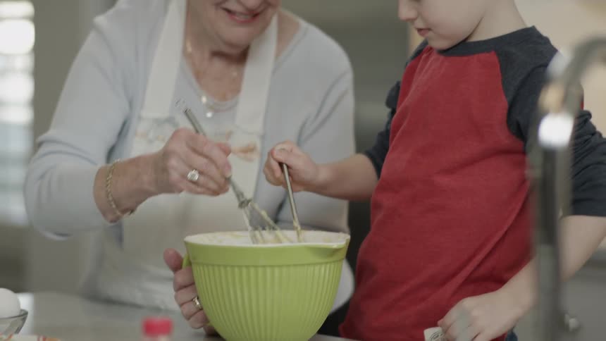 A woman and child mix a bowl