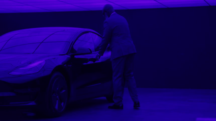 A man walking up to and getting into a car