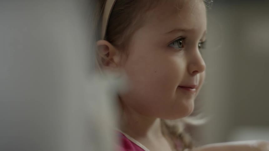 A girl looks around mixing a bowl