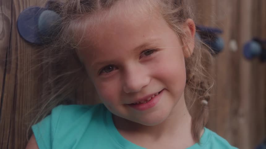 A girl smiles at the camera