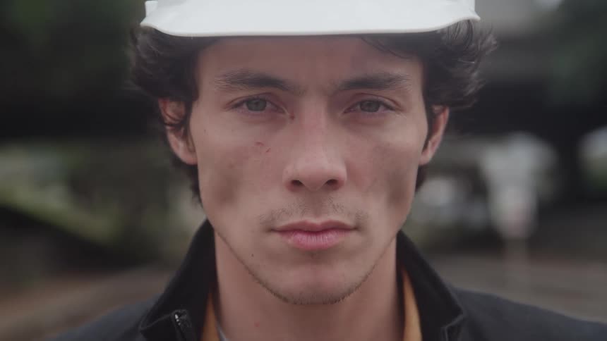 The construction worker is wearing a white hard hat