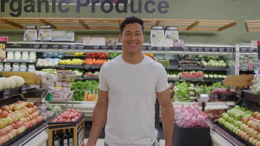 Man looks at produce section in grocery store