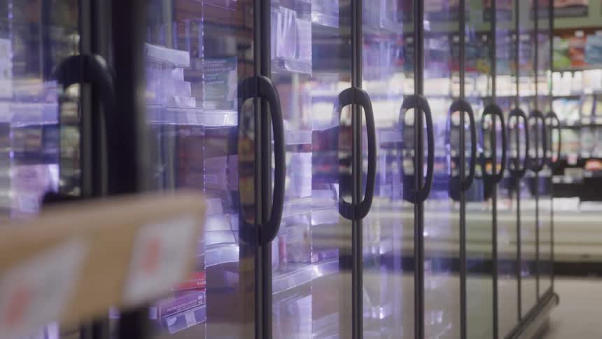 Glassdoor freezers display frozen foods in supermarket