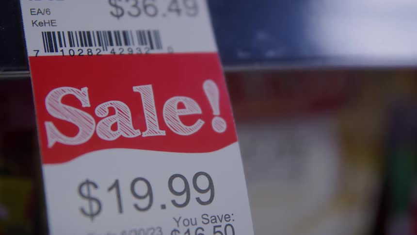 A product inside a retail store displays a sales tag clearly marked with a sale price of 1999 usd