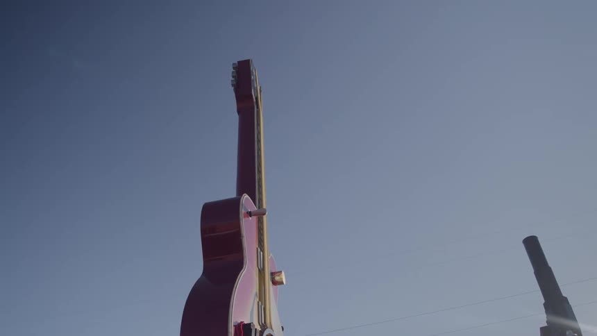 Oversized guitar stands out against blue sky