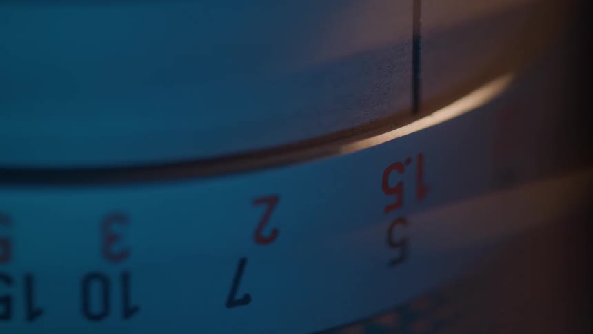 Metallic numbered scale lit by warm light in a detailed closeup