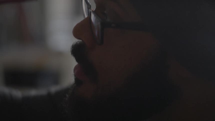 A man is working on something with a paint brush