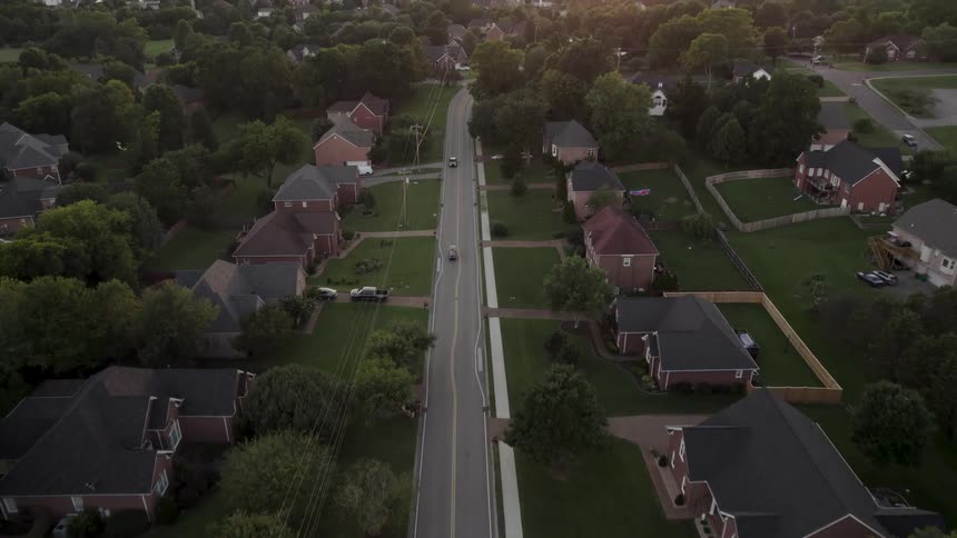 Vehicles drive on the road in the suburbs