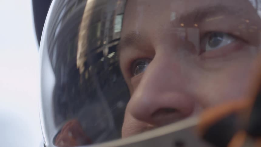 A man closes the lid on his space helmet