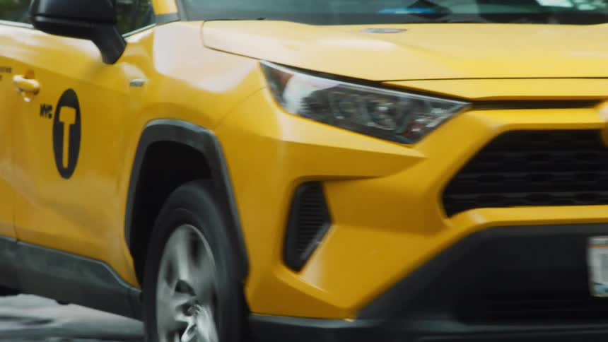 Taxi cab travels on a busy city street