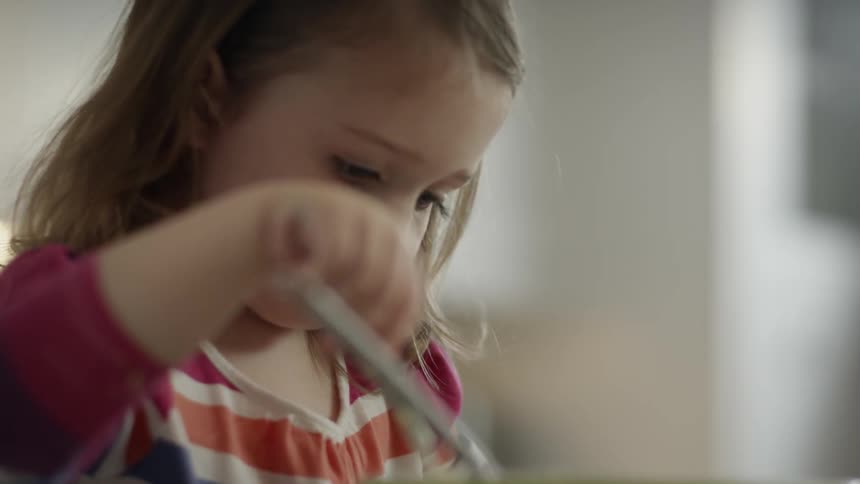 A girl is mixing a bowl in a kitchen