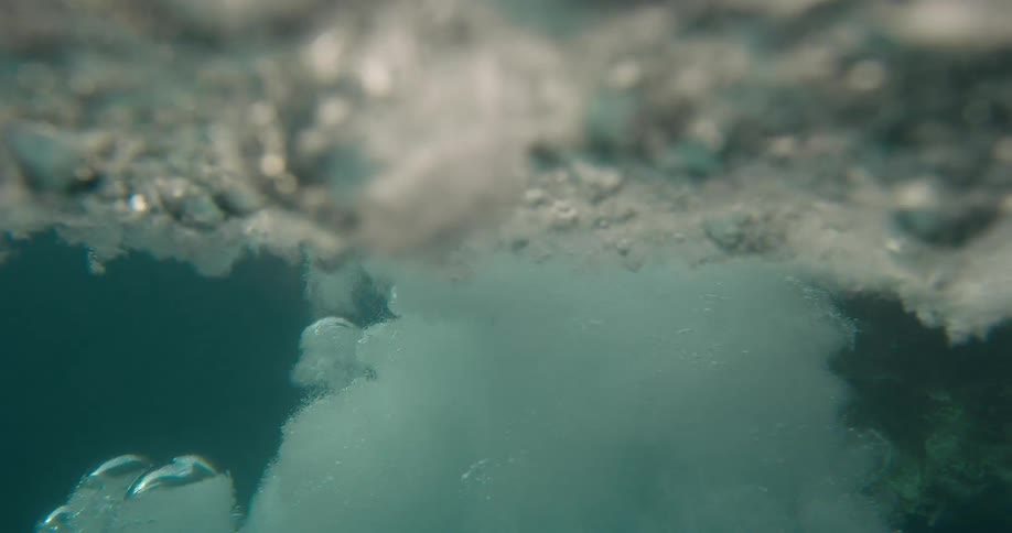 A man diving off of a cliff into water