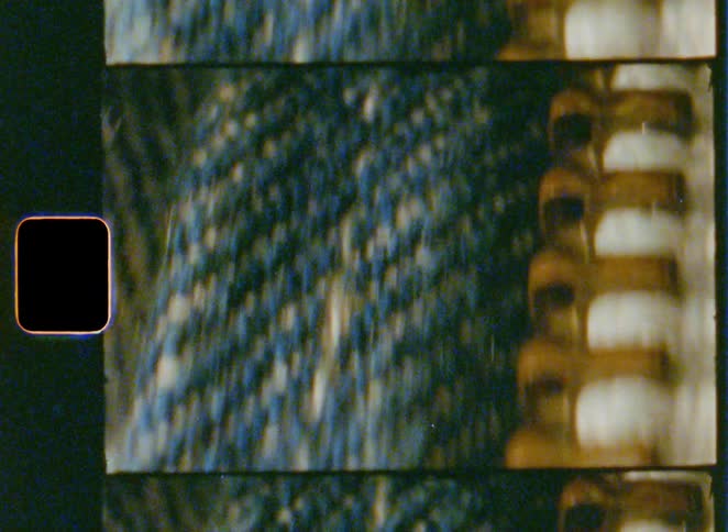 Zipper on pants appears in detail with surrounding fabric texture